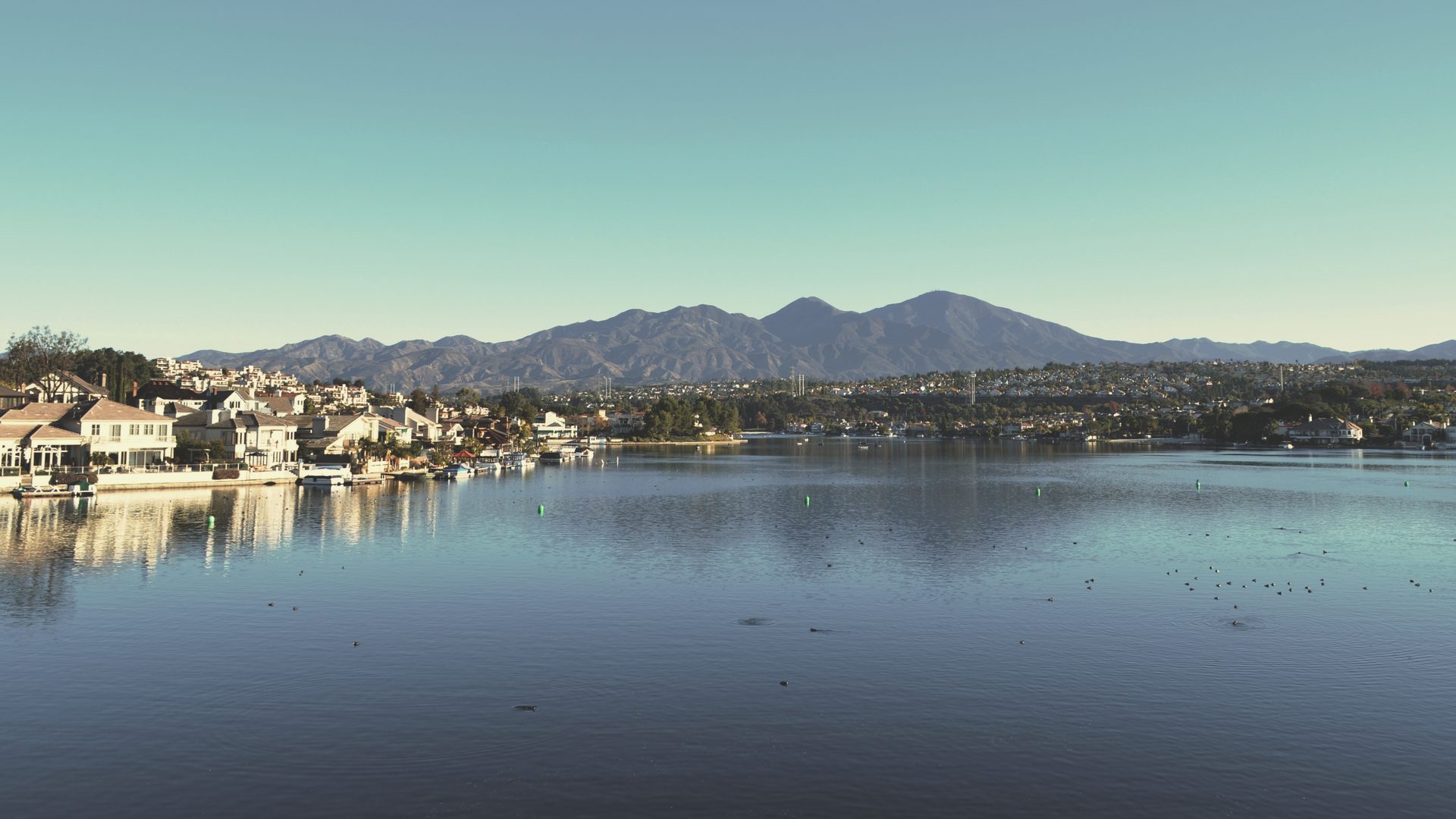 Homes along Lake Mission Viejo with Saddleback in the distance.